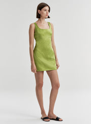 Woman wearing a green dress on a white background