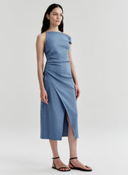 Woman wearing a blue one-shoulder dress on a light gray background