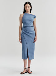 Woman wearing a blue one-shoulder dress on a light gray background