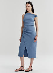 Woman wearing a blue one-shoulder dress on a light gray background