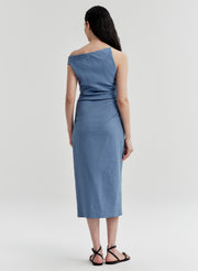 Woman wearing a blue one-shoulder dress on a light gray background