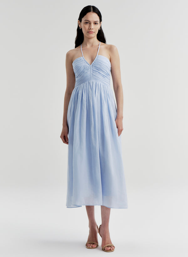 Woman wearing a light blue dress on a white background