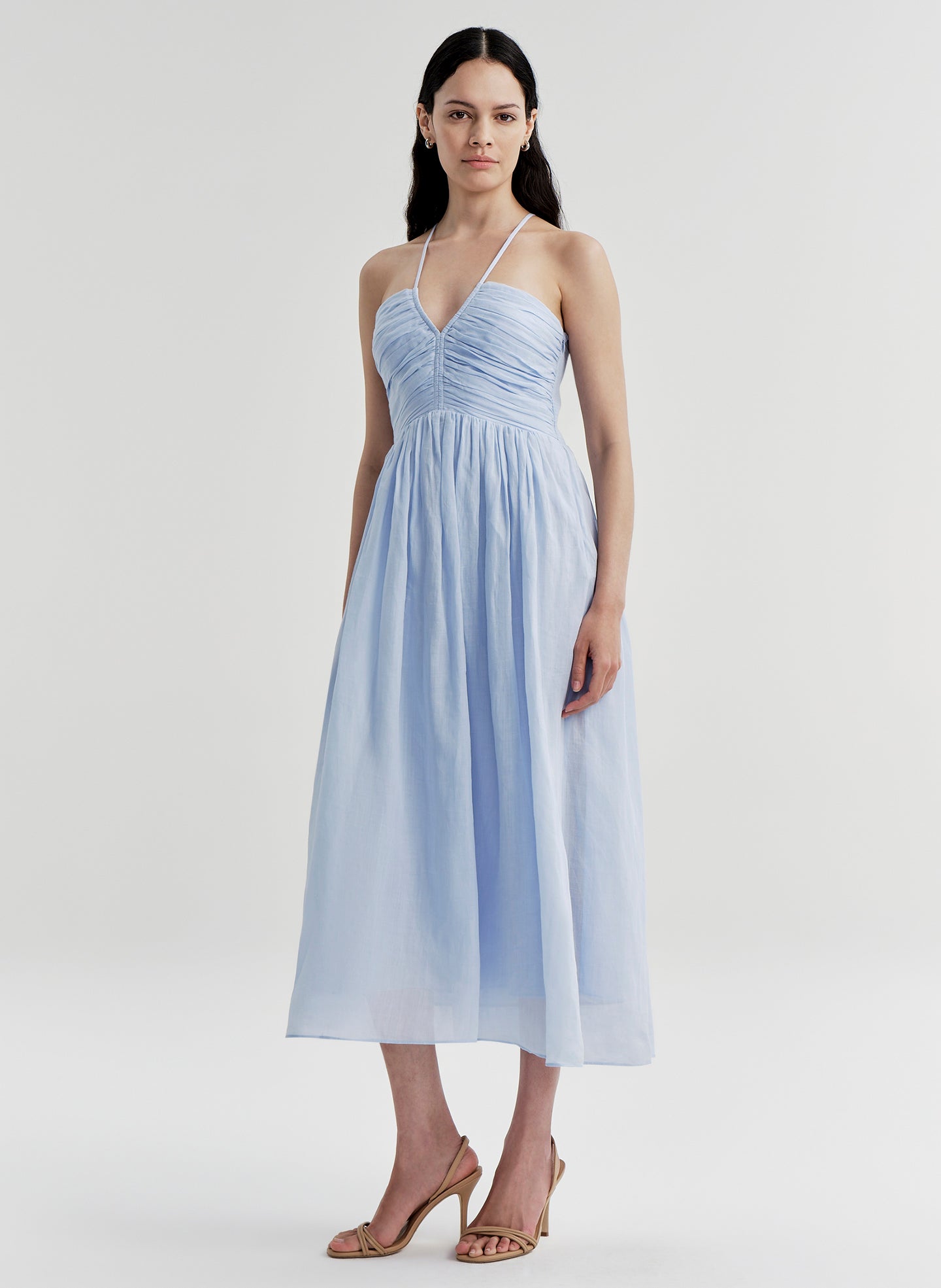 Woman wearing a light blue dress on a white background