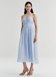 Woman wearing a light blue dress on a white background