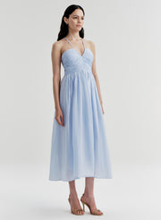 Woman wearing a light blue dress on a white background
