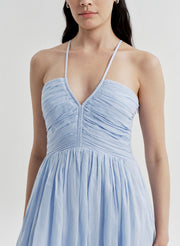 Woman wearing a light blue dress on a white background