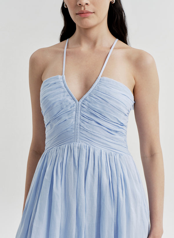 Woman wearing a light blue dress on a white background