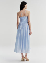 Woman wearing a light blue dress on a white background