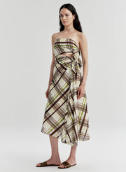 Woman wearing a cotton plaid strapless dress on a white background