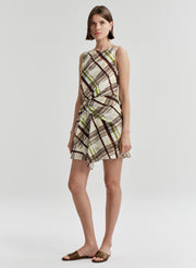 Woman wearing a plaid dress on a white background
