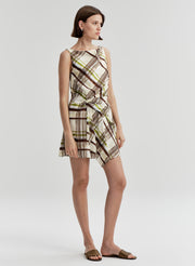 Woman wearing a plaid dress on a white background
