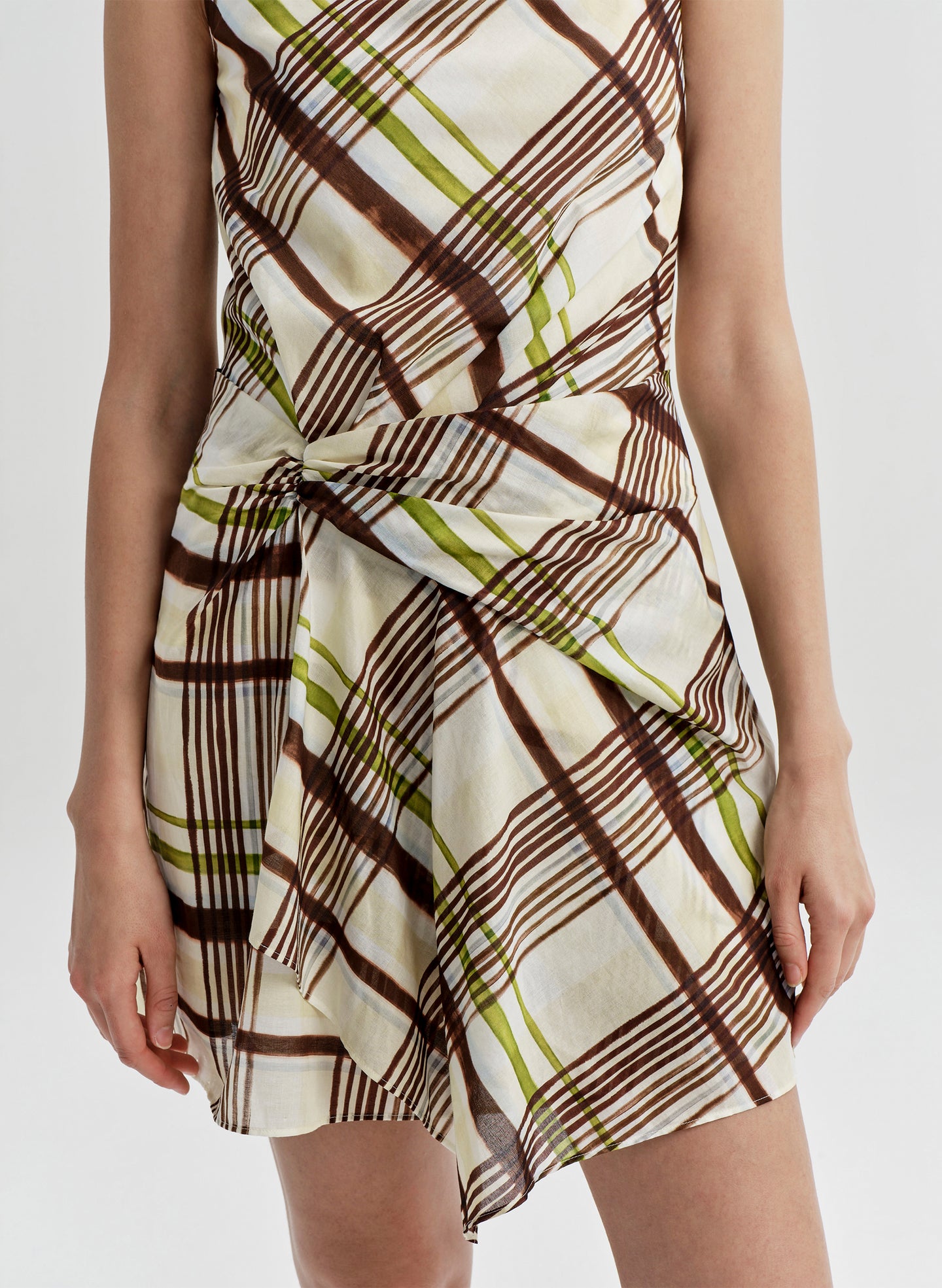 Woman wearing a plaid dress on a white background