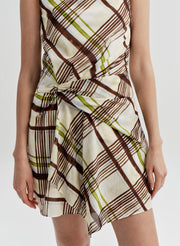 Woman wearing a plaid dress on a white background