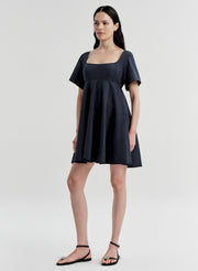 Woman wearing a dark blue dress on a white background