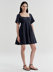 Woman wearing a dark blue dress on a white background