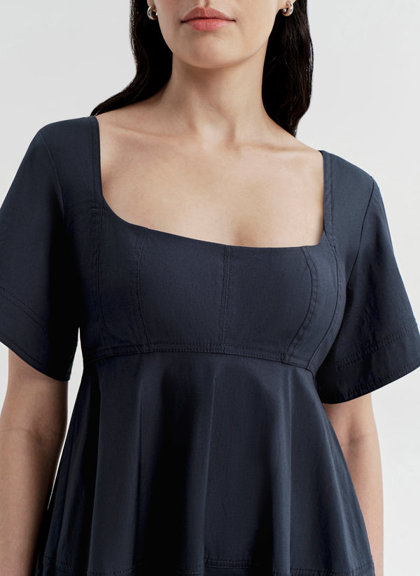 Woman wearing a dark blue dress on a white background
