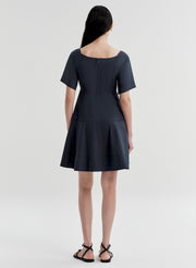 Woman wearing a dark blue dress on a white background