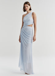 Woman wearing a light blue one-shoulder dress on a white background