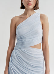 Woman wearing a light blue one-shoulder dress on a white background