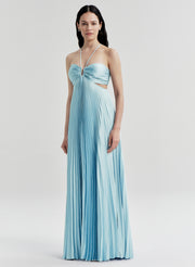 Woman wearing a light blue pleated dress on a white background