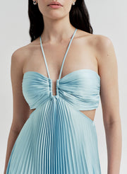 Light blue pleated dress worn by a model on a plain background