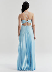 Woman wearing a light blue pleated dress with thin straps on a white background