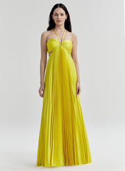 Woman wearing a yellow pleated dress on a white background