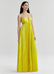 Woman wearing a yellow pleated dress on a white background