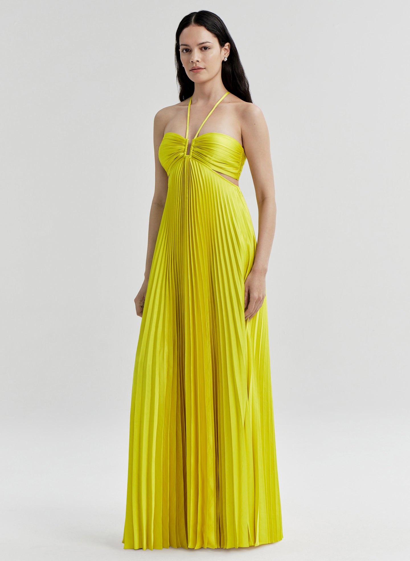 Woman wearing a yellow dress on a white background