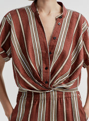 Striped linen shirt with a knot detail on a plain background