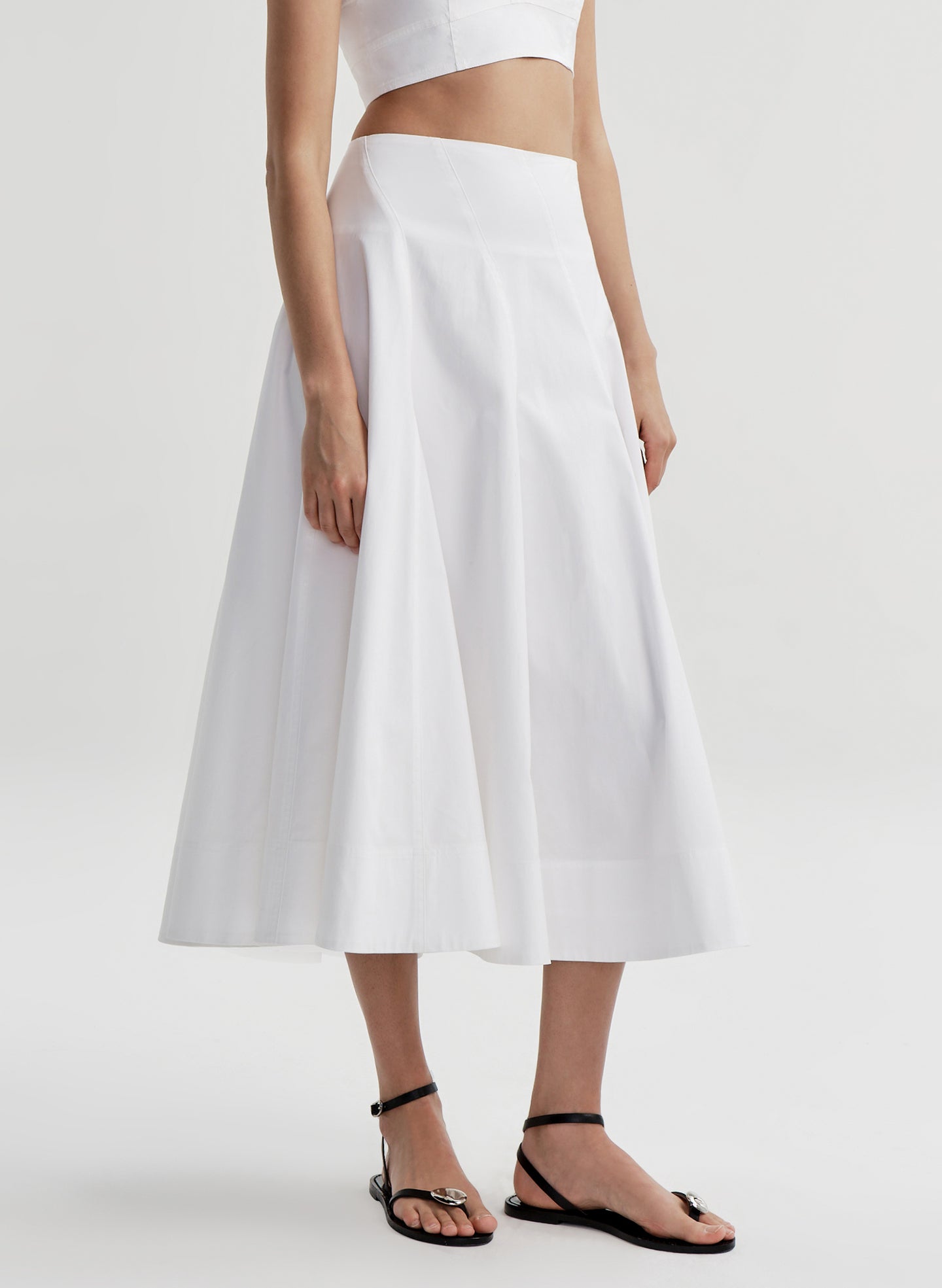 Woman wearing a white skirt with a white background 