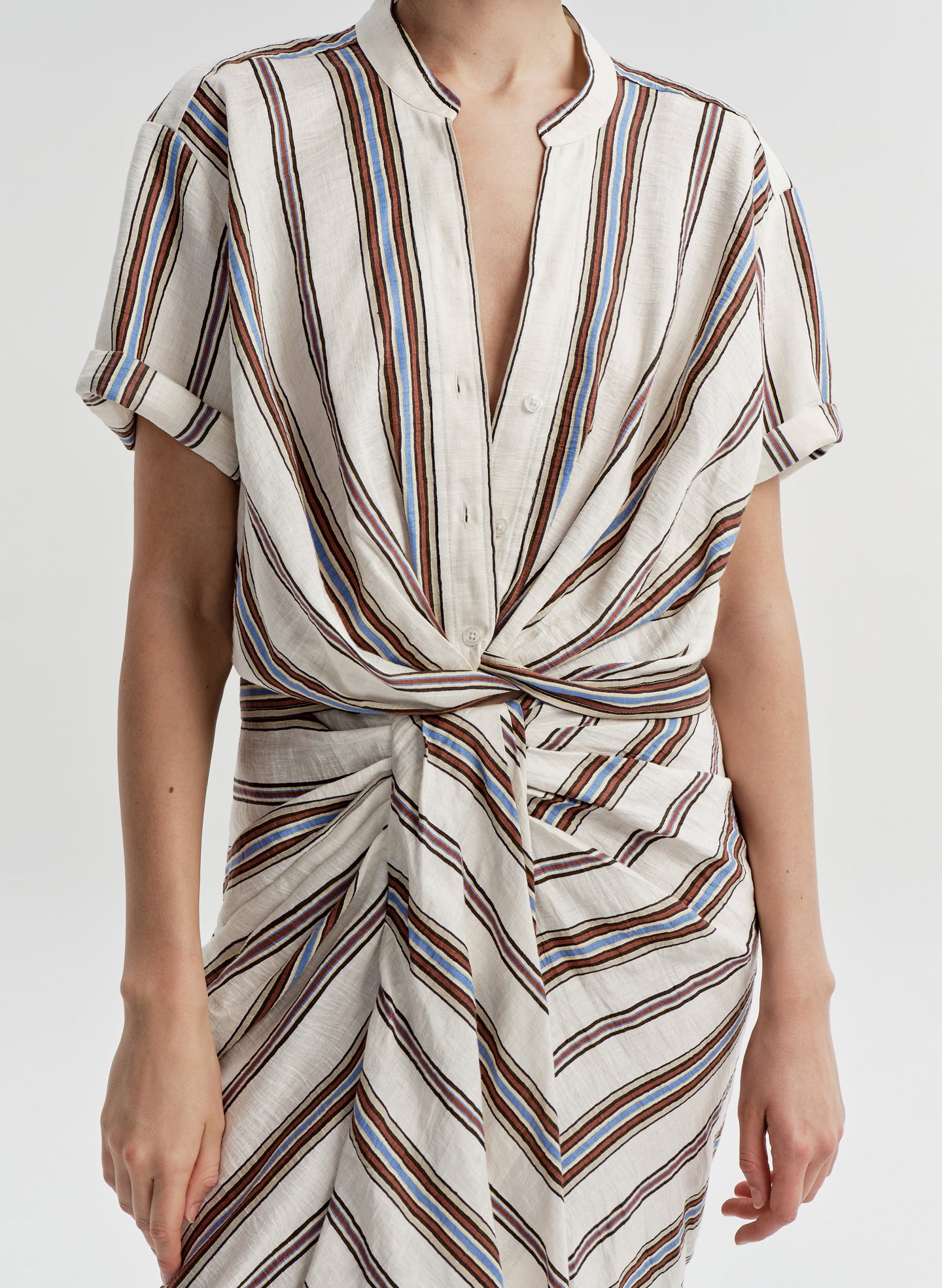 Striped top with a knot detail on a white background