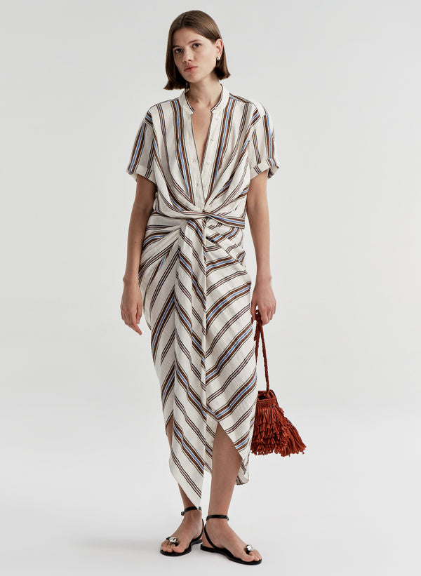 Woman wearing a striped linen skirt with a matching top on a plain background