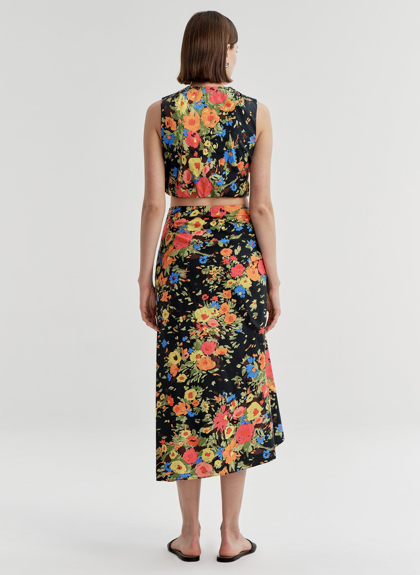 woman wearing floral shirt and skirt set