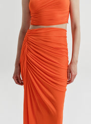 Orange ruched top and skirt set on a white background