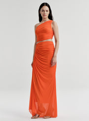 Woman wearing an orange one-shoulder top with a matching skirt on a white background