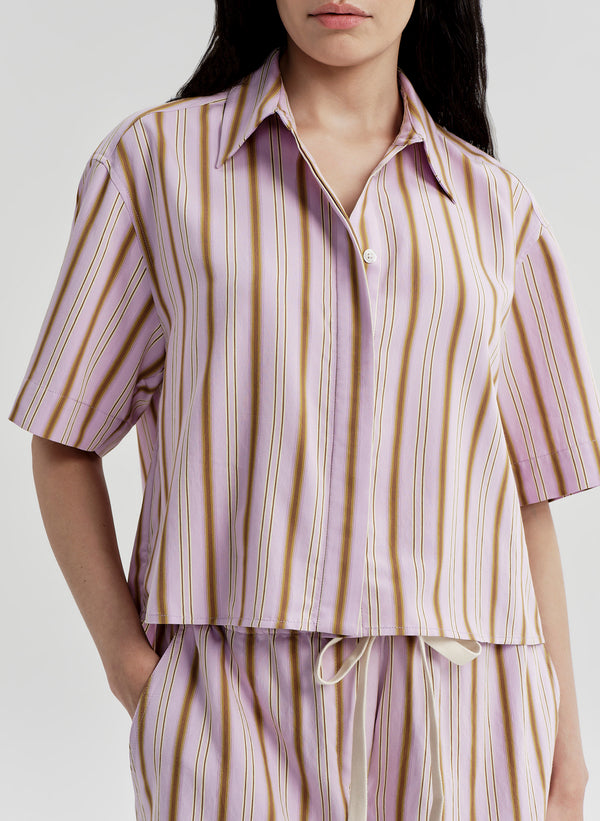 Person wearing a striped shirt and pants set on a plain background