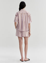 Person wearing a striped shirt and shorts set on a white background