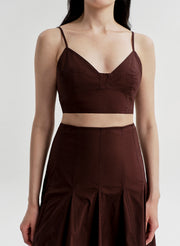 Woman wearing a brown top and skirt set on a white background