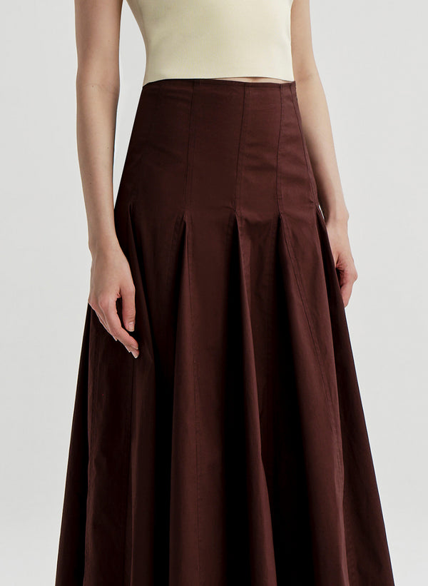 Brown skirt worn by a person on a plain background