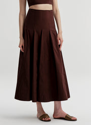 Woman wearing a brown skirt on a plain background