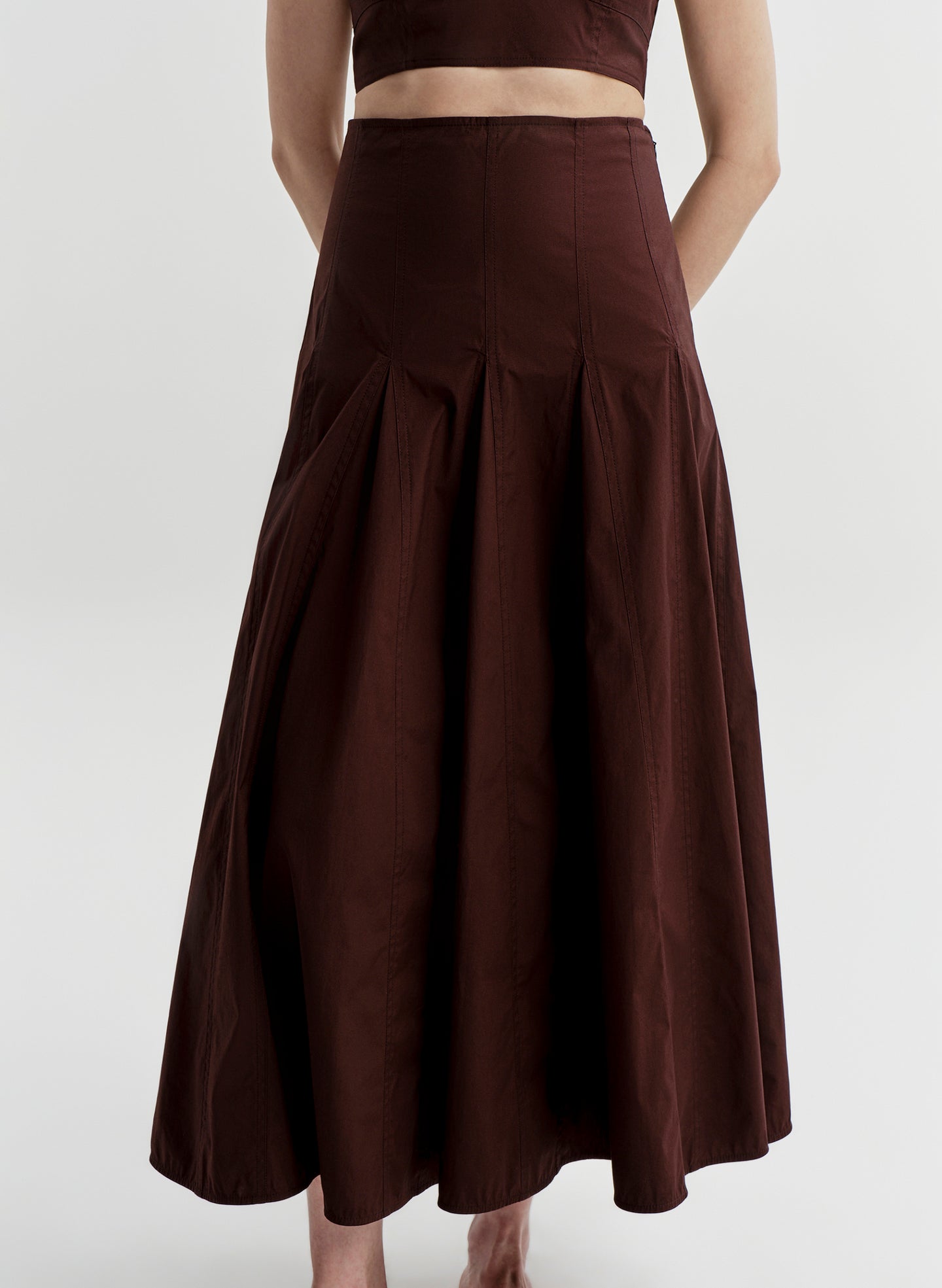 Woman wearing a brown skirt on a white background