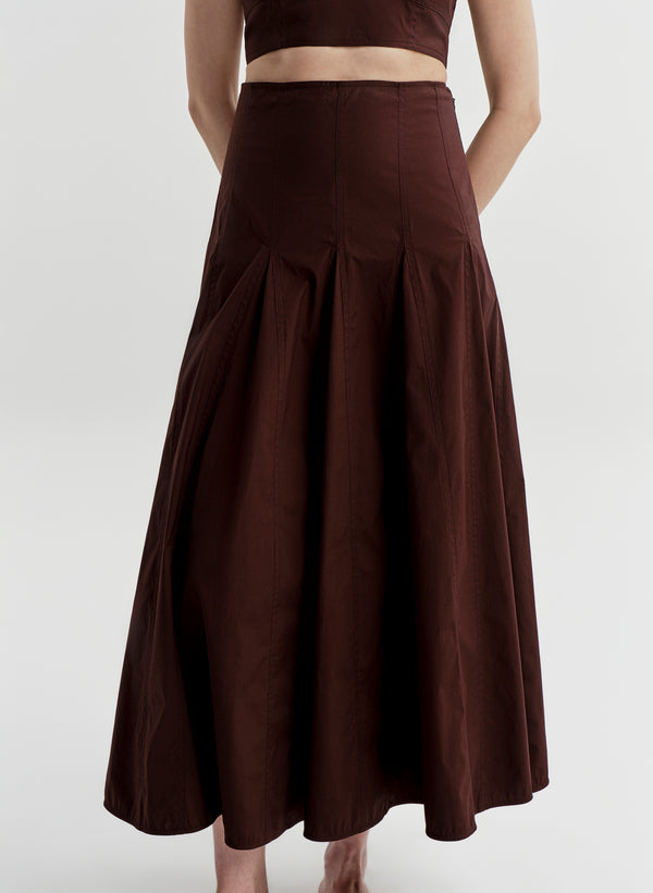 Woman wearing a brown skirt on a white background