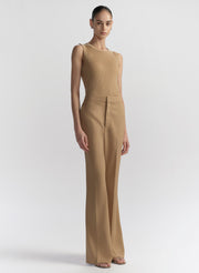 woman wearing tan sleeveless top and tan pants