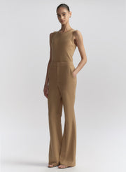 woman wearing tan sleeveless top and tan pants