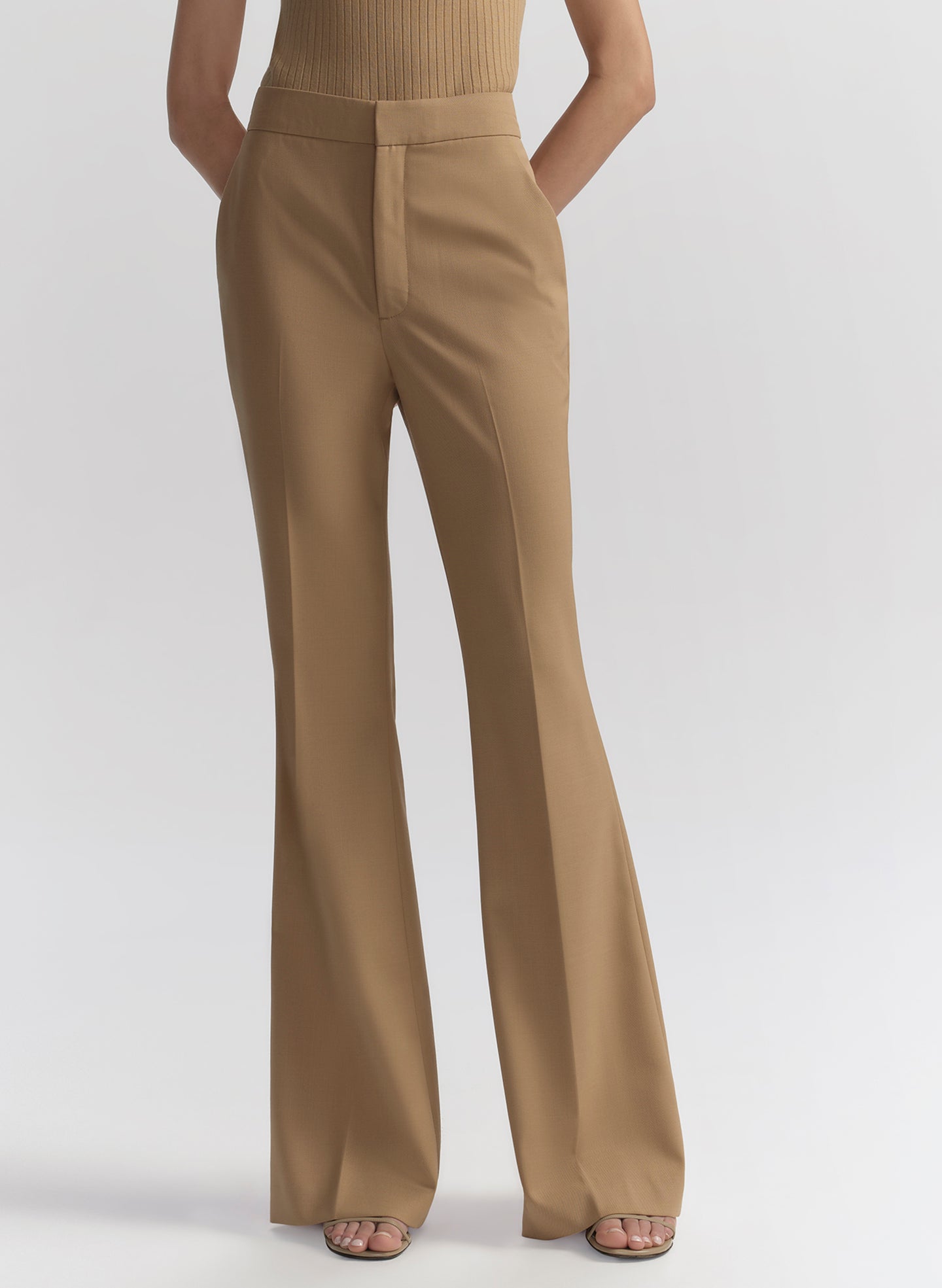 woman wearing tan sleeveless top and matching pants