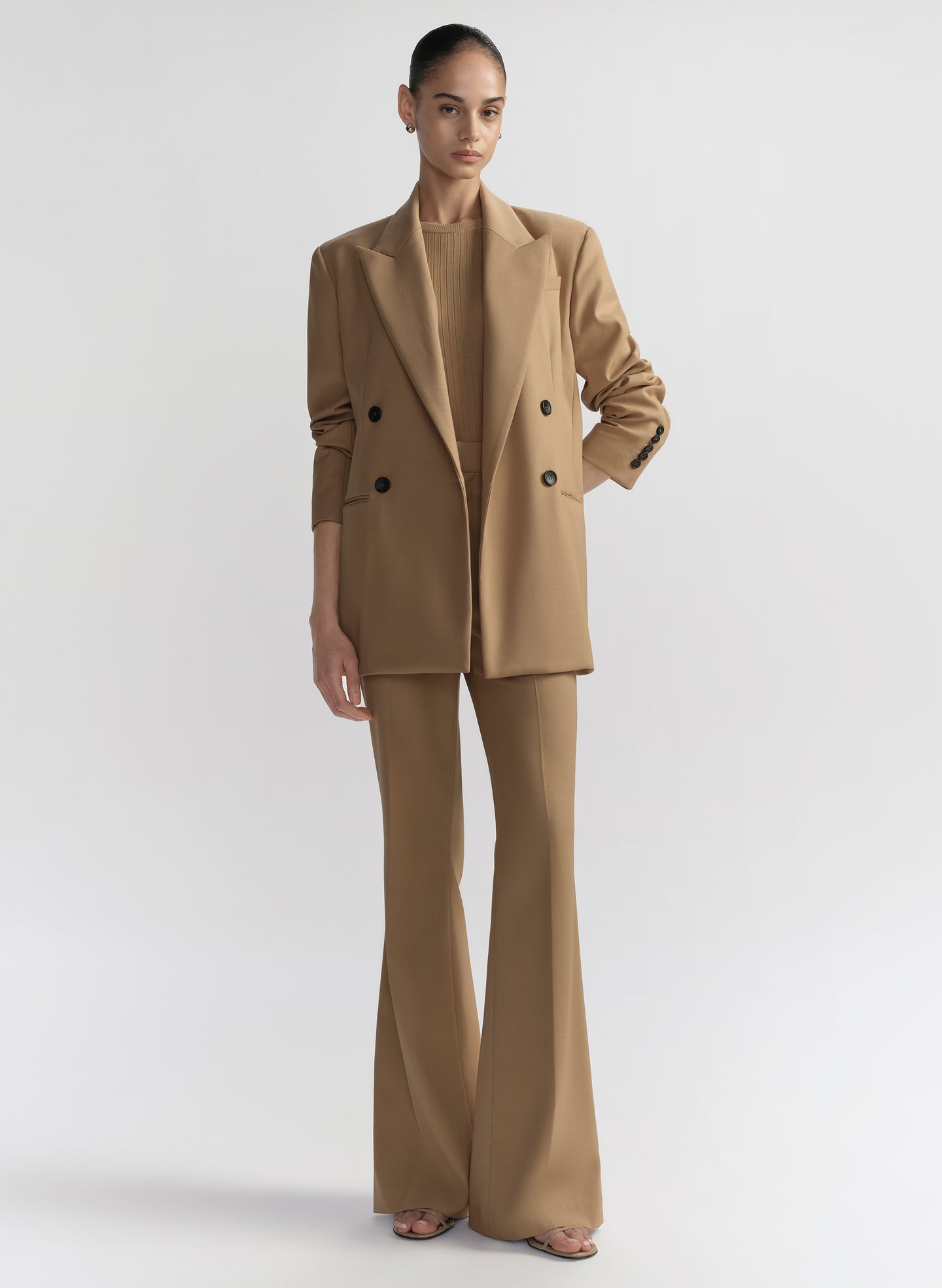 woman wearing tan suit