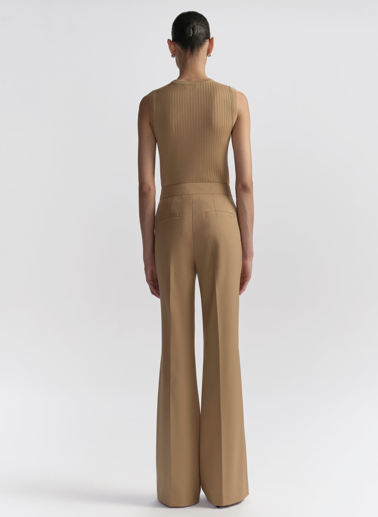 woman wearing tan sleeveless top and matching pants