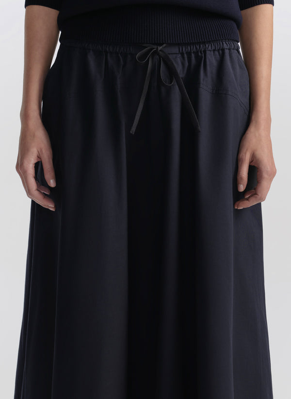 woman wearing blue sweater and skirt