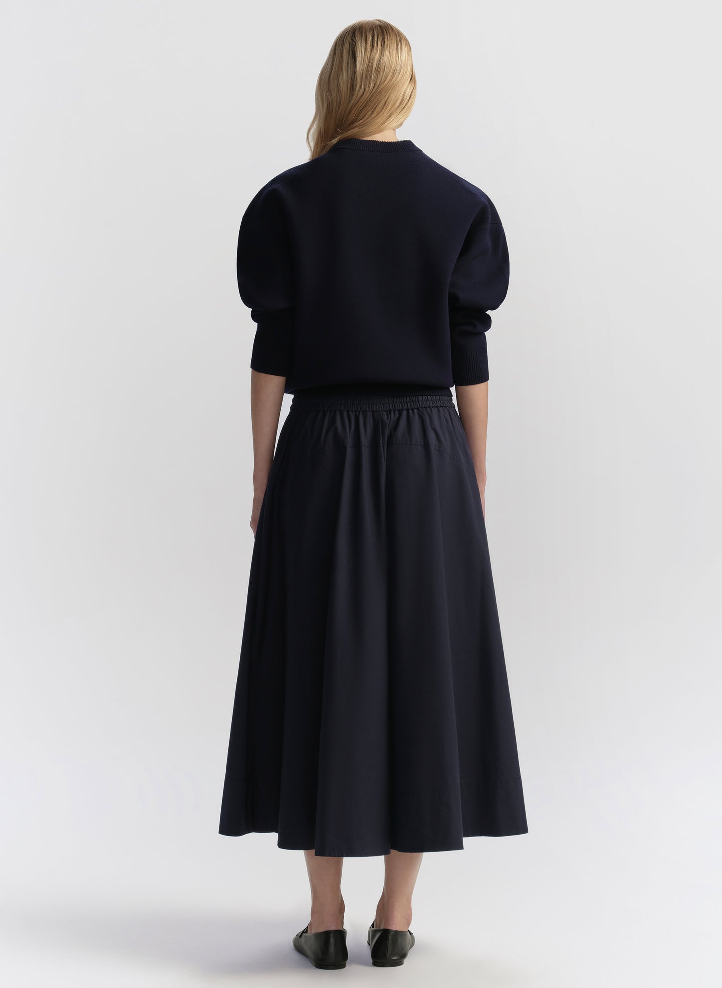 woman wearing blue sweater and skirt